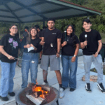 group of male and female teenagers from catholic youth group in south omaha roasting smores